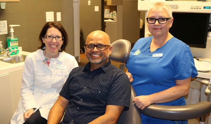 Doctor and staff member with patient at ABC Dentistry