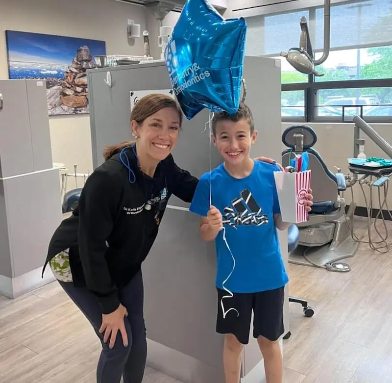 Friendly staff at abc dentistry with a young orthodontic patient.
